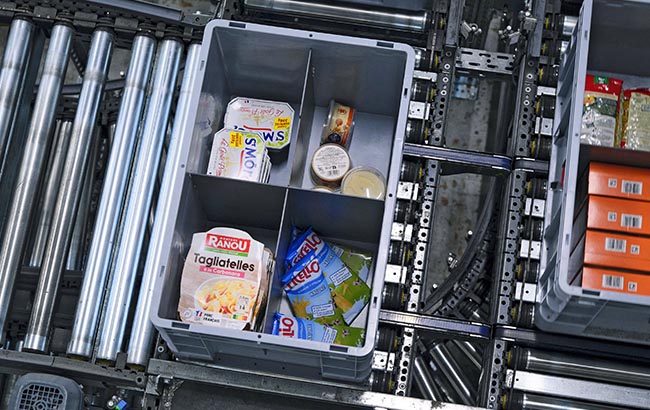 Crate filled with assorted grocery items, representing organized order preparation and efficient food retail fulfillment supported by streamlined KNAPP intralogistics processes.
