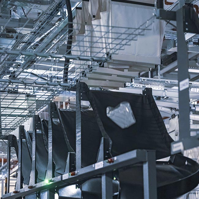 Precision pocket-drop mechanism releasing items accurately into designated totes or destinations to support high-throughput sortation, sequencing, and scalable omnichannel fulfillment.