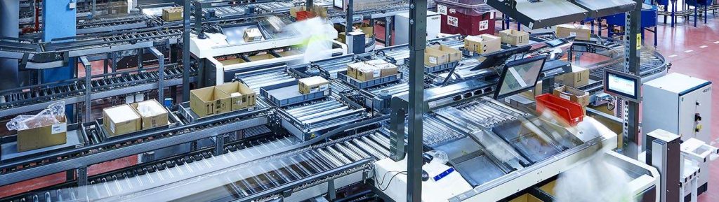 Large overview image of KNAPP low‑touch ecommerce automation in a distribution center, showing integrated picking, conveying, sorting, and robotic systems working together to reduce manual handling, increase speed, and deliver scalable fulfillment efficiency.