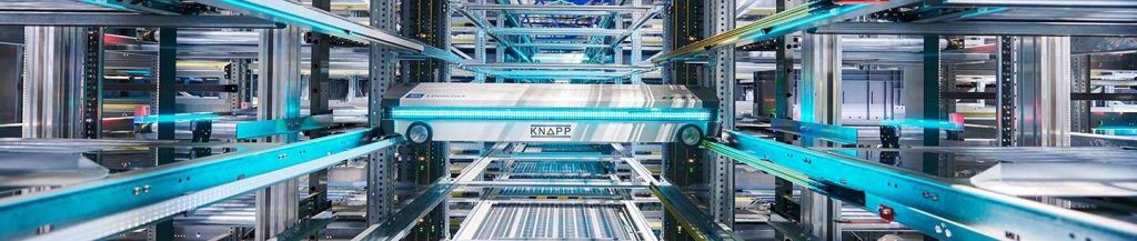 Wide image of the KNAPP EVO Shuttle high‑density storage system, showing multi‑level shuttle vehicles operating in a rack structure to deliver fast, scalable, and energy‑efficient tote handling for modern automated warehouses.