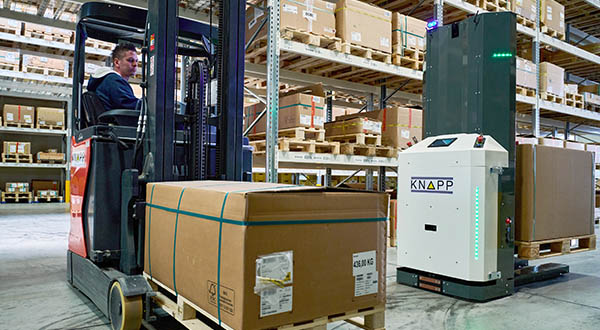 Photograph of an autonomous mobile robot emphasizing evade‑ability, showing how AMRs that rely on virtual lines may stop when encountering human workers and highlighting the need for advanced, fully safe systems capable of smooth evasive maneuvering to maintain productivity in mixed‑traffic warehouse environments.