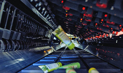 product processing system automating the inspection, handling, and routing of goods to improve accuracy, throughput, and operational efficiency in high‑volume distribution environments.