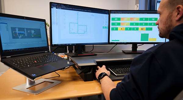 Photograph showing an AMR testing or evaluation scenario, illustrating the importance of simulate‑ability in autonomous mobile robot deployments, where virtual modeling and digital testing help organizations validate performance, avoid trial‑and‑error approaches, and optimize changes before rollout in a real warehouse environment.