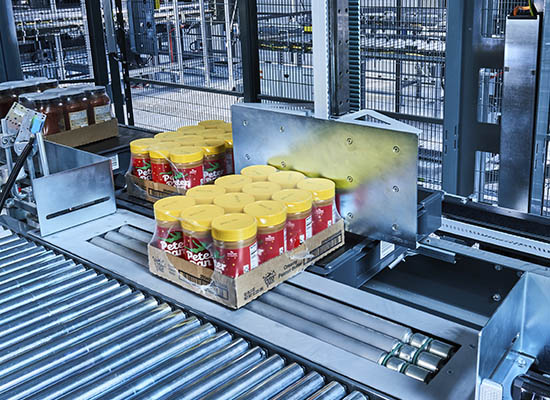 runpick case handling system transporting individual cases along a high‑speed conveyor to support flexible, scalable, and cost‑efficient omnichannel distribution operations.