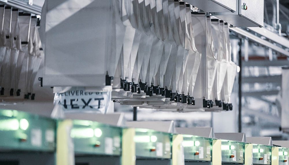 Pockets moving along an automated sorter system, illustrating how rising consumer expectations drive the need for faster, more accurate, and scalable eCommerce fulfillment using KNAPP pocket technology.