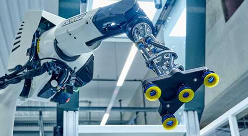 robotic gripper handling items with precision to demonstrate end‑of‑arm tooling capabilities for automated picking in warehouse operations.