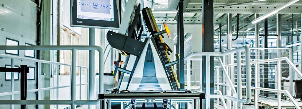 Central belt retrofit system enabling fully automated product handling with improved quality control, enhanced security features, and efficient throughput for modernized warehouse operations.