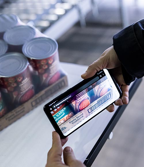 Mobile device scanning grocery items to enable real‑time inventory accuracy, streamlined replenishment, and faster checkout experiences in modern retail fulfillment environments.