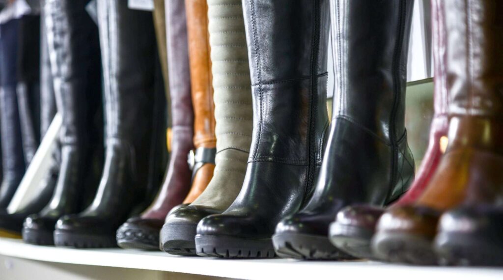 Retail display of durable boots designed for everyday consumer wear, highlighting footwear quality, style, and suitability for efficient e‑commerce fulfillment and in‑store sales operations.