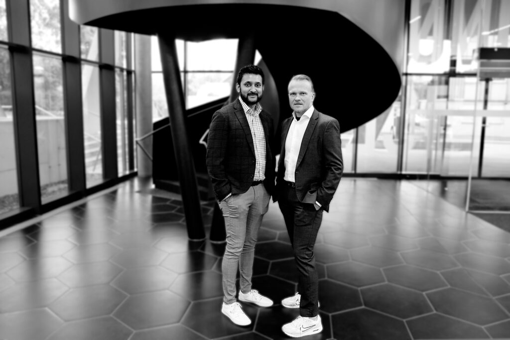 KNAPP senior and executive vice presidents of customer service in North America standing together in a professional setting, representing leadership, expertise, and commitment to high‑quality service across automated warehouse operations.